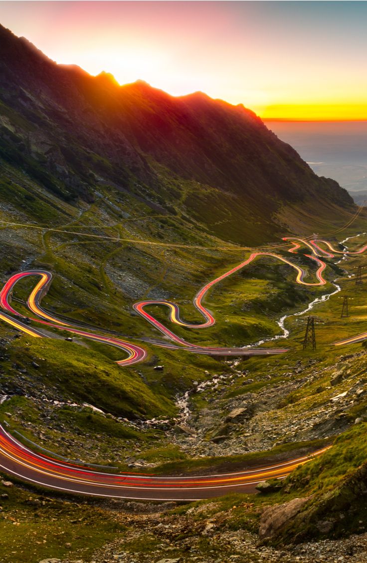Traffic trails on Transfagarasan pass at sunset_ Crossing Carpathian mountains in Romania, Transfagarasan is one of the most spectacular mountain roads in the world_